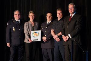 Members of the Emergency & Health Services Commission’s Clinical Education Development Team accepting their plaque from BCPSQC Chair Doug Cochrane at Health Talks
