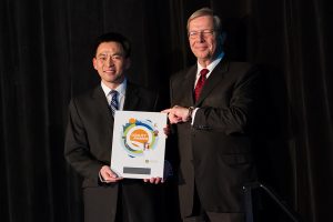 Dennis Jang accepting his plaque from BCPSQC Chair Doug Cochrane at Health Talks