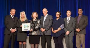 Members of the Rapid Access to Consultative Expertise team receive its plaque from BCPSQC Chair Doug Cochrane at Health Talks