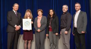 Members of the Transitioning Patients To and From the BC Cancer Agency and Vancouver General Hospital initiative’s team receive its plaque from BCPSQC Chair Doug Cochrane at Health Talks